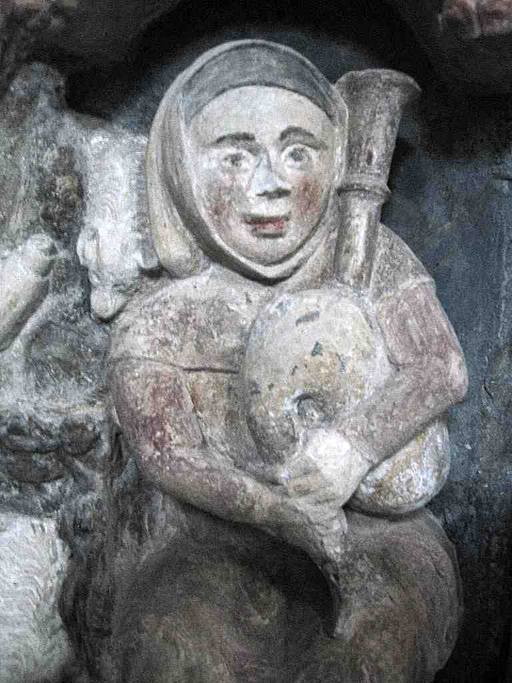 Le joueur de cornemuse sculpté sur le retable du Caylar